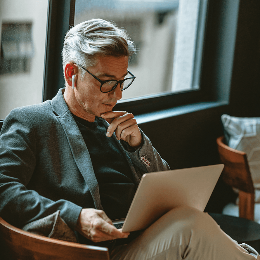 Person reading content from a laptop.