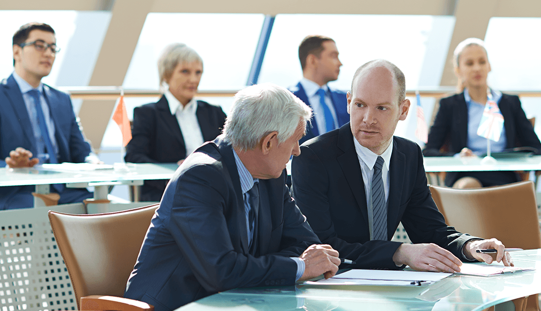 Two People in Suits Having a Serious Discussion