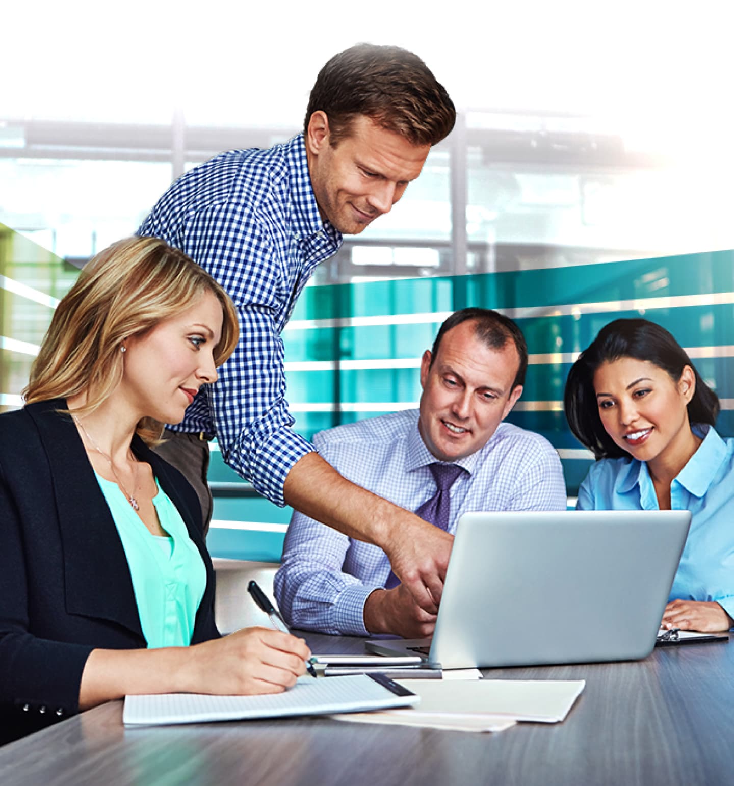 Four People Working Off One Laptop in Meeting