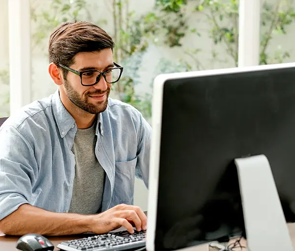 Man Smiling at Computer