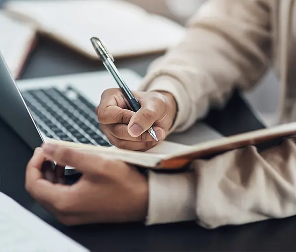 Person Writing in Journal