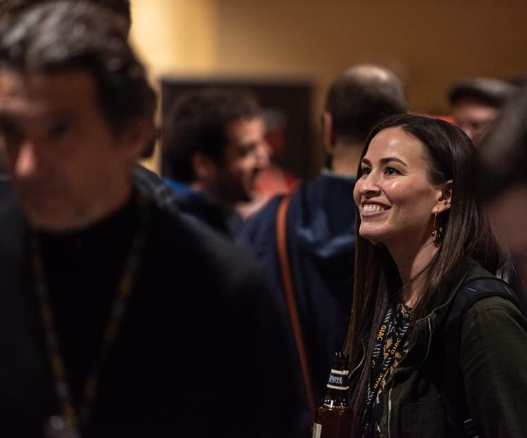 Woman Smiling While Attending a Summit